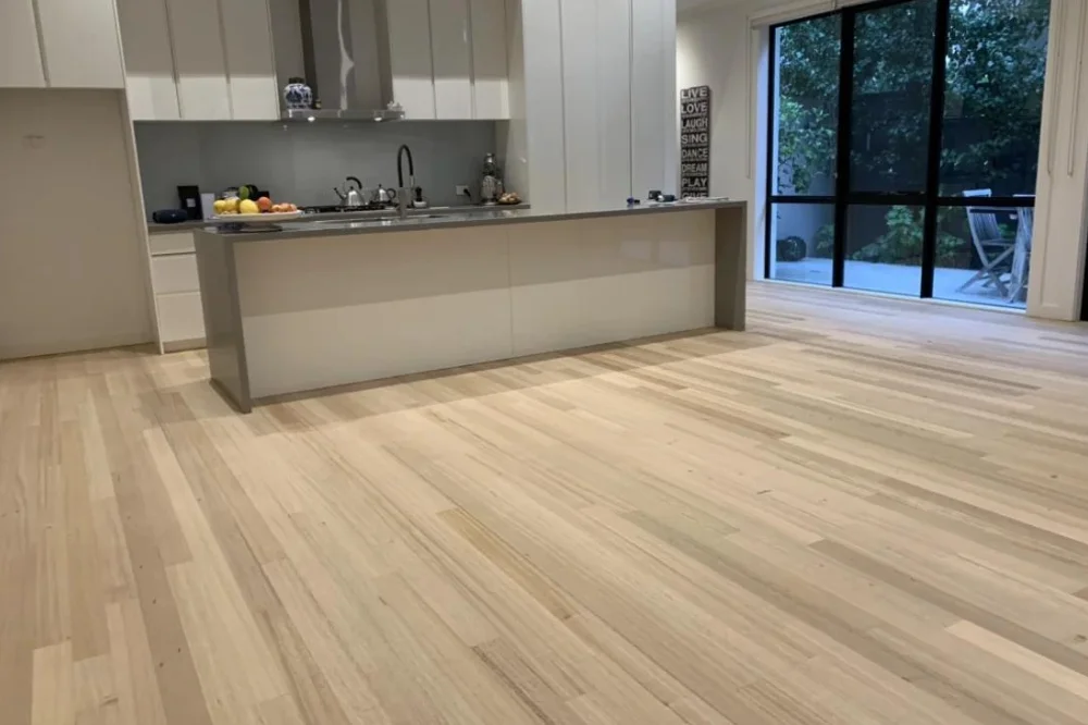 Freshly polished timber floor in a modern kitchen renovation